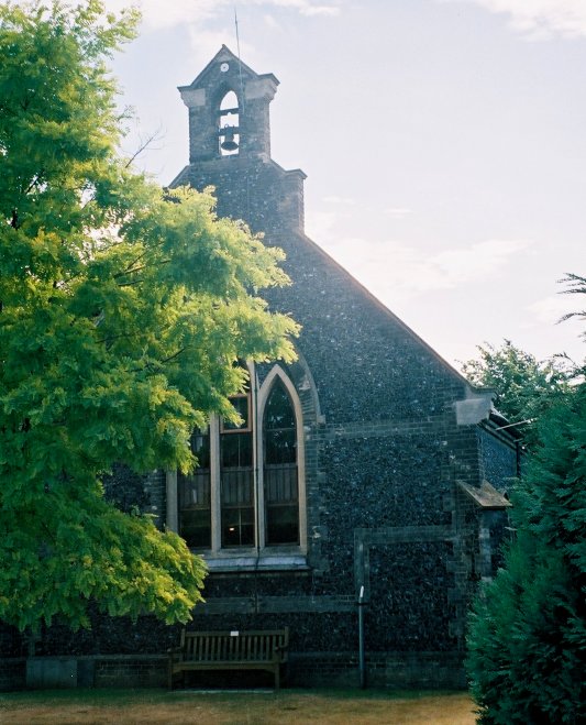 Coy behind its cluster of trees: the Newmarket workhouse chapel.