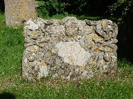 cherub flanked by skulls and crossed bones