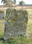 An 18th century stone with cherub and scrollwork.